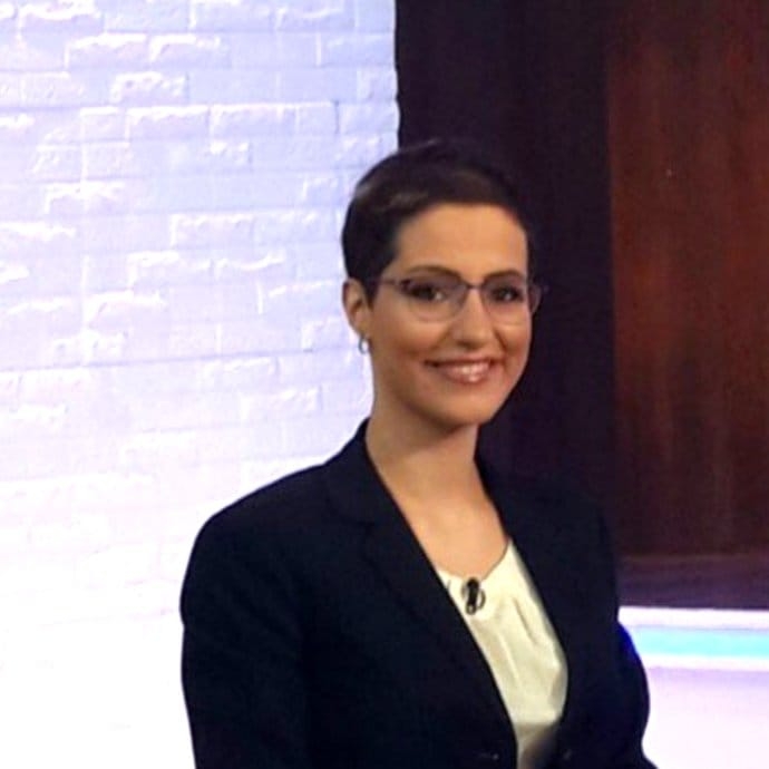 Image of Rita Kamel on a TV set.